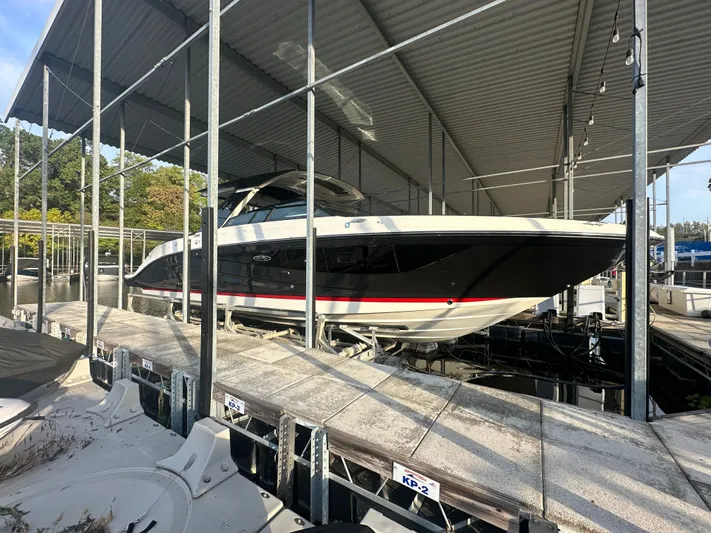  Yacht Photos Pics 2022 Sea Ray SLX 400 boat docked under a covered marina.