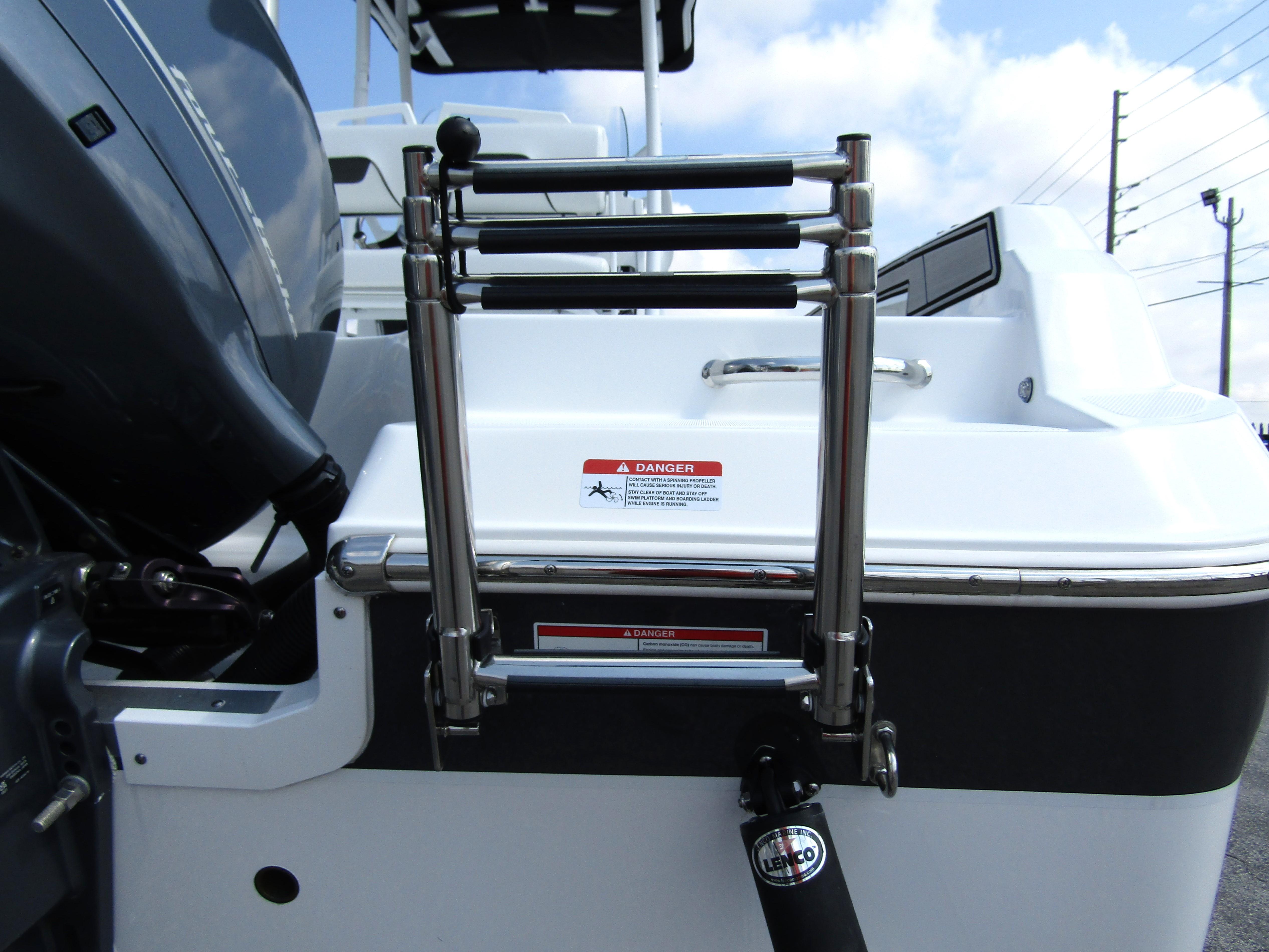 2024 Wellcraft 202 Fisherman boat ladder and engine detail under a blue sky.