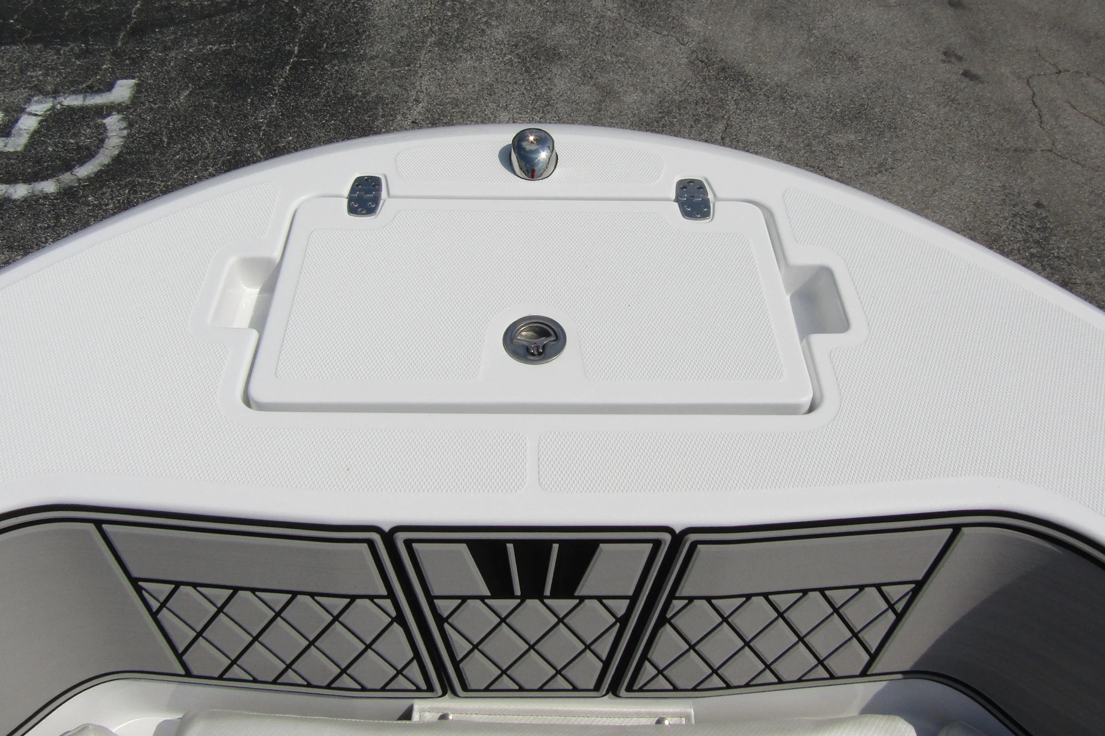 2024 Wellcraft 202 Fisherman boat deck with storage compartment and netted side panels.