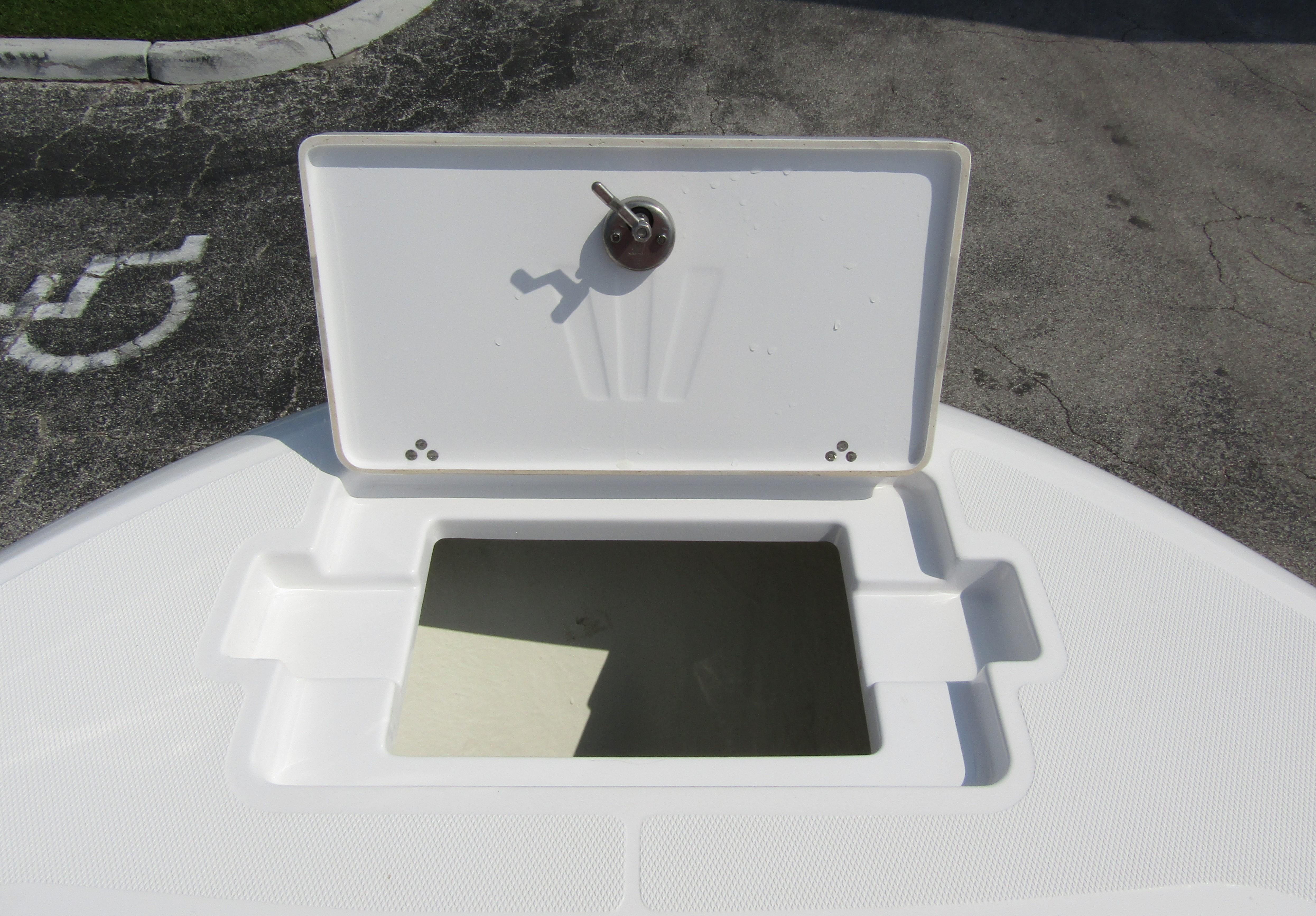 Open storage compartment on 2024 Wellcraft 202 Fisherman boat.