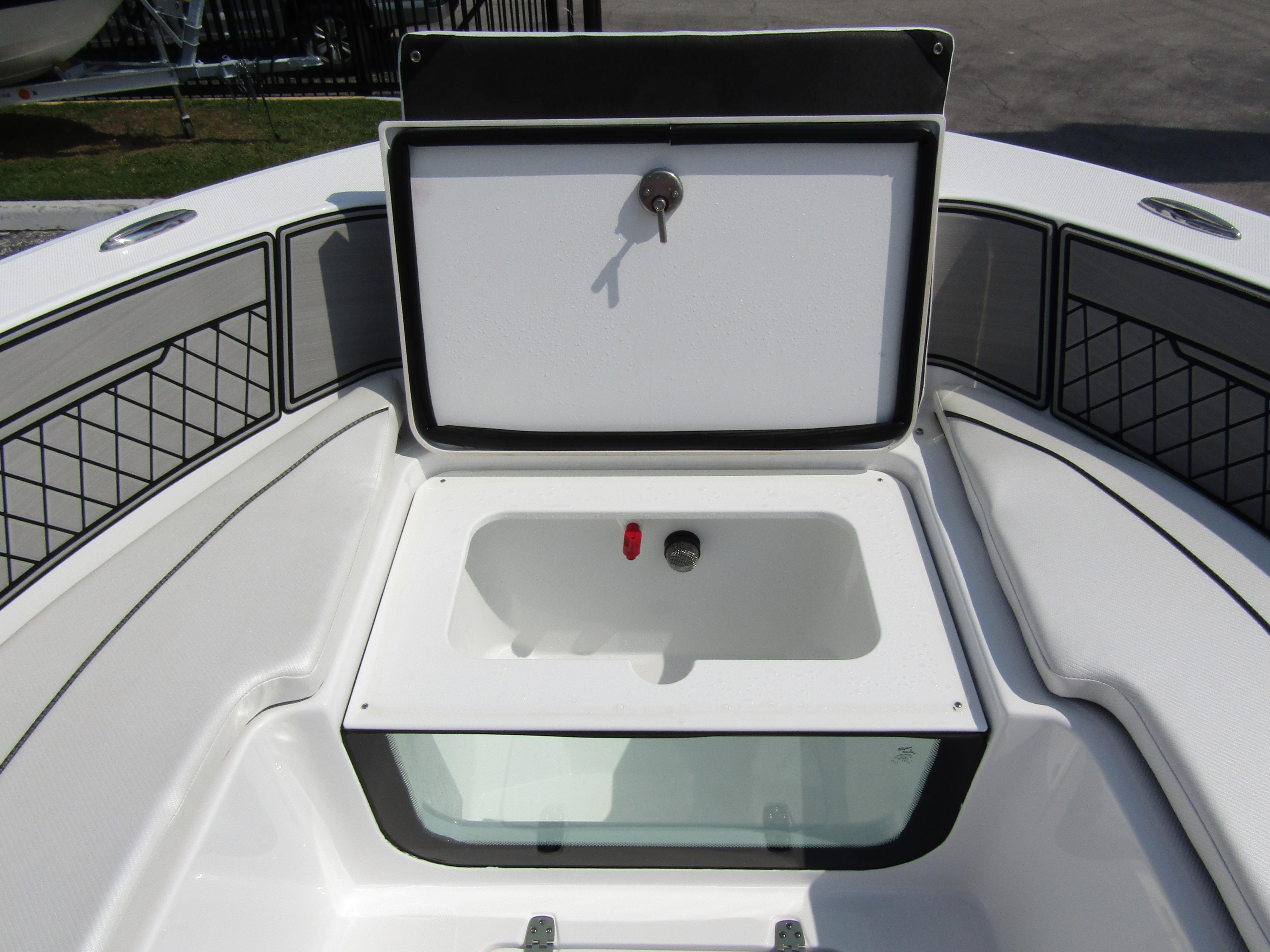 2024 Wellcraft 202 Fisherman boat storage compartment with open lid.