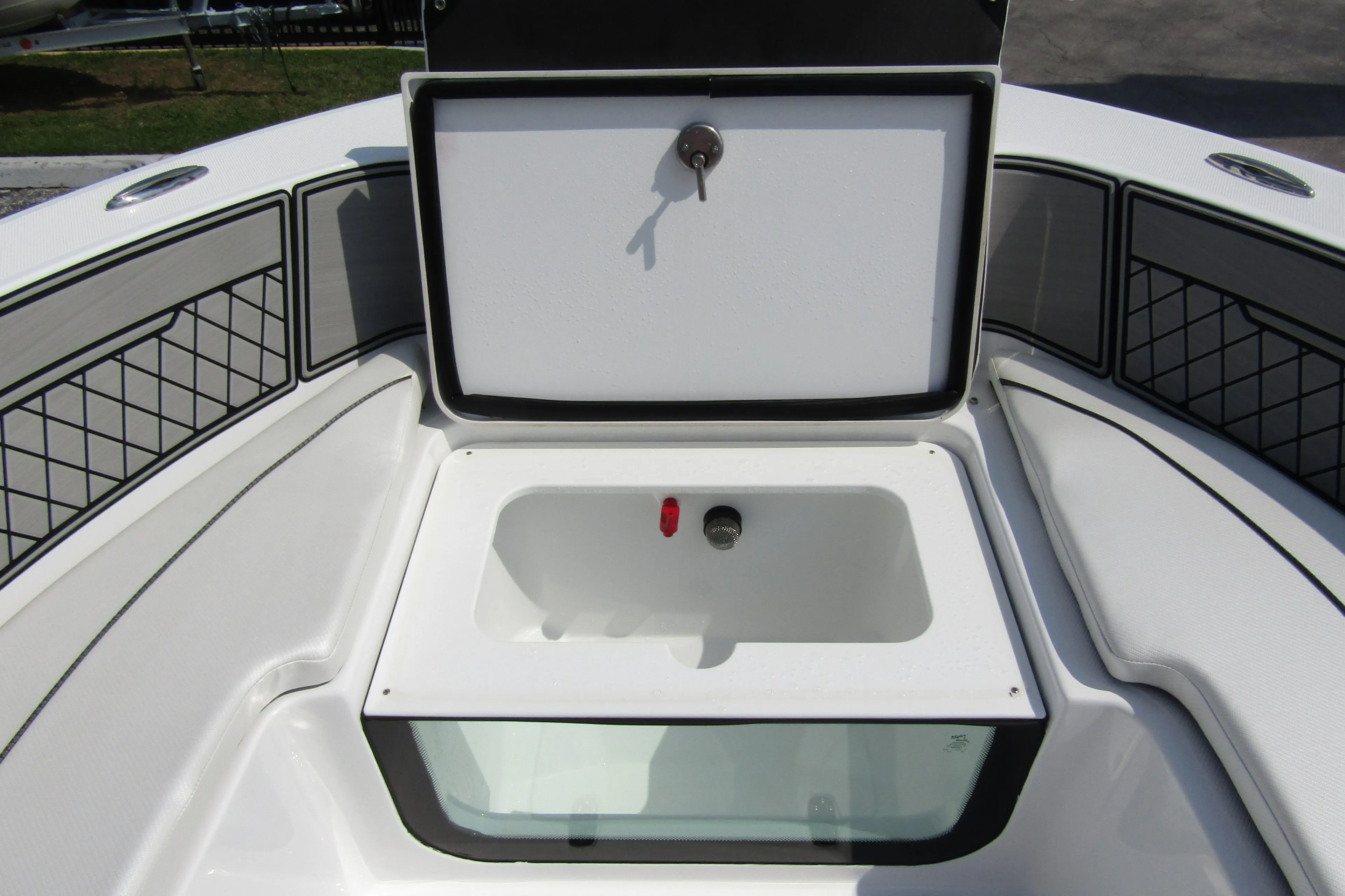 2024 Wellcraft 202 Fisherman boat storage compartment with open lid.