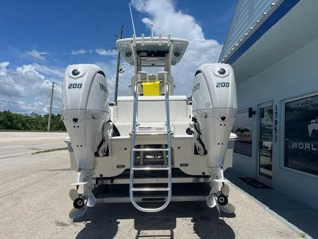  Yacht Photos Pics 2024 World Cat 260 CC-X boat with dual Yamaha 200 engines, parked outdoors.