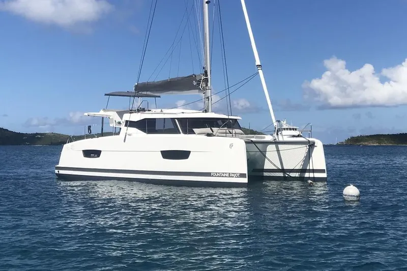 Paire De Jacques Yacht Photos Pics 2021 Fountaine Pajot Isla 40 catamaran sailing on calm blue waters.