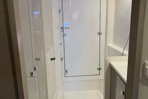 Paire De Jacques Yacht Photos Pics 2021 Fountaine Pajot Isla 40 yacht bathroom with modern shower and sleek design.