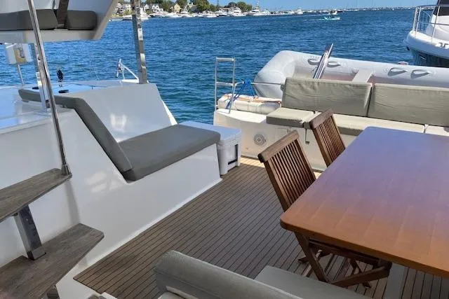Paire De Jacques Yacht Photos Pics Outdoor seating area on 2021 Fountaine Pajot Isla 40 catamaran with ocean view.