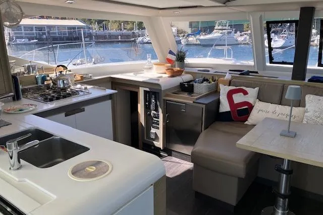 Paire De Jacques Yacht Photos Pics Interior of 2021 Fountaine Pajot Isla 40 catamaran with modern kitchen and seating area.
