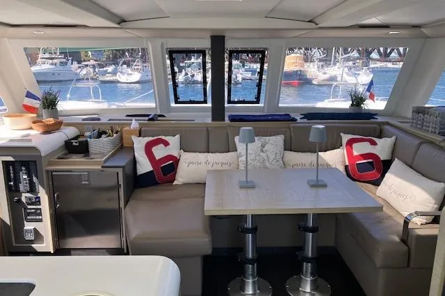 Paire De Jacques Yacht Photos Pics Interior of 2021 Fountaine Pajot Isla 40 catamaran with cozy seating and nautical decor.