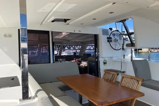 Paire De Jacques Yacht Photos Pics Spacious interior of 2021 Fountaine Pajot Isla 40 catamaran with dining area and helm.