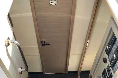 Paire De Jacques Yacht Photos Pics Interior view of 2021 Fountaine Pajot Isla 40 yacht, featuring a WC door and control panel.