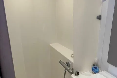 Paire De Jacques Yacht Photos Pics Shower area in 2021 Fountaine Pajot Isla 40 catamaran, featuring modern fixtures and soap dispenser.