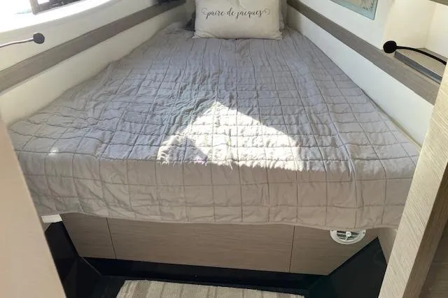 Paire De Jacques Yacht Photos Pics Cozy bedroom interior of 2021 Fountaine Pajot Isla 40 catamaran with a neatly made bed.