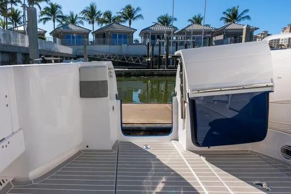  Yacht Photos Pics 2023 Intrepid 438 Evolution yacht docked, featuring sleek deck design and modern amenities.