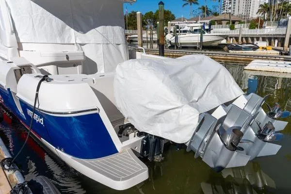  Yacht Photos Pics 2023 Intrepid 438 Evolution boat docked with covered engines.