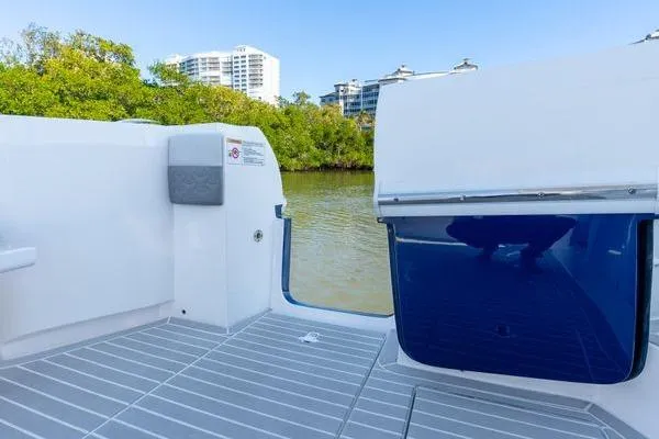  Yacht Photos Pics 2023 Intrepid 438 Evolution boat deck with water and cityscape view.