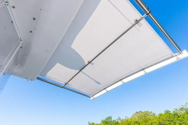  Yacht Photos Pics 2023 Intrepid 438 Evolution boat canopy against clear blue sky.