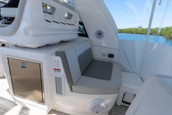  Yacht Photos Pics 2023 Intrepid 438 Evolution boat interior with seating and storage, featuring modern design elements.