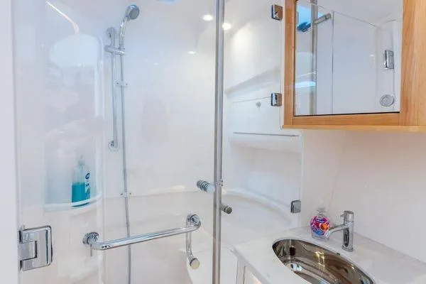  Yacht Photos Pics 2023 Intrepid 438 Evolution yacht bathroom with modern shower and sink.