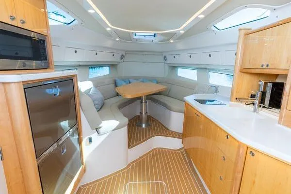  Yacht Photos Pics Luxurious interior of 2023 Intrepid 438 Evolution yacht with modern kitchen and seating area.