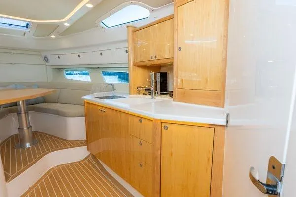  Yacht Photos Pics Luxurious interior of 2023 Intrepid 438 Evolution yacht with modern kitchen and seating area.