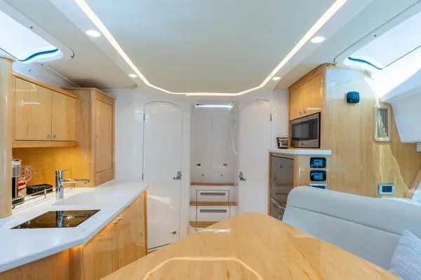  Yacht Photos Pics Luxurious interior of 2023 Intrepid 438 Evolution yacht with modern kitchen amenities.