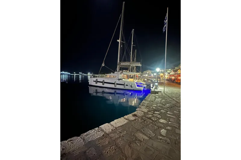  Yacht Photos Pics Night view of a 2017 Bali 4.3 catamaran docked at a lit harbor.
