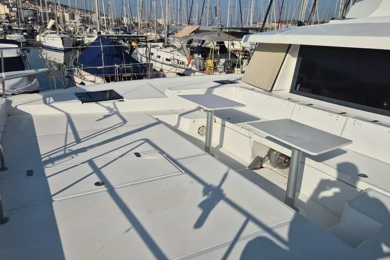  Yacht Photos Pics Spacious deck of 2017 Bali 4.3 catamaran in marina, featuring tables and seating.