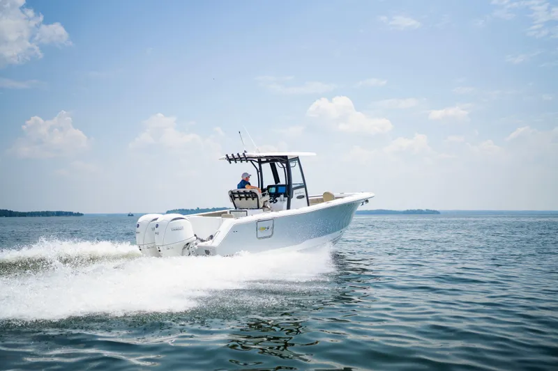 Yacht Photos Pics 2026 Sea Hunt Gamefish 25 cruising on open water under a clear sky.