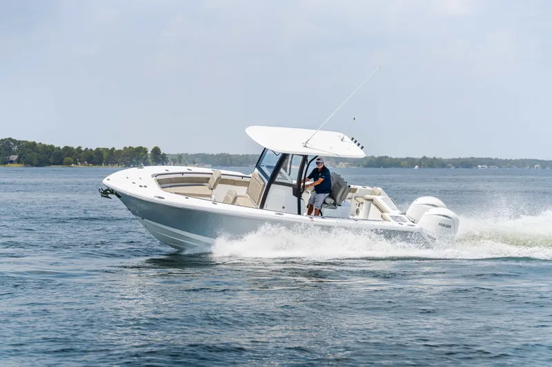  Yacht Photos Pics 2026 Sea Hunt Gamefish 25 cruising on a lake with a person steering.