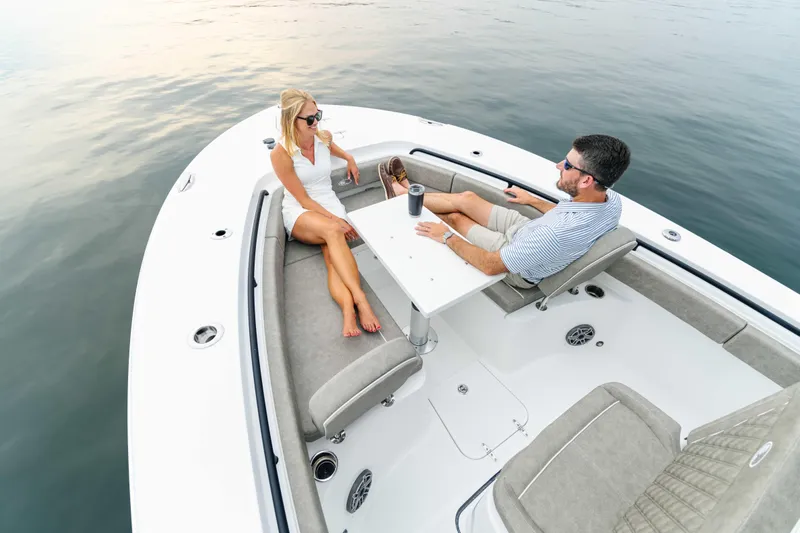  Yacht Photos Pics Couple relaxing on 2026 Sea Hunt Gamefish 25 boat, enjoying a serene water view.
