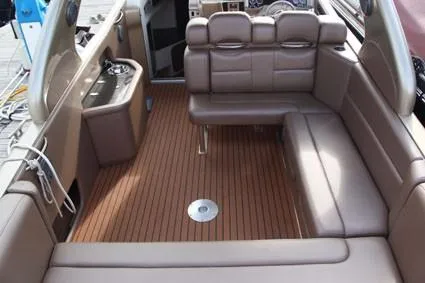  Yacht Photos Pics Luxurious interior of 2010 Nor-Tech 52 boat with brown leather seating and wood flooring.