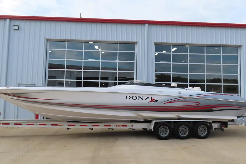  Yacht Photos Pics 2007 Donzi 35 ZR speedboat on trailer, parked outside a modern garage.