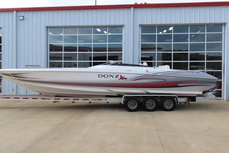  Yacht Photos Pics 2007 Donzi 35 ZR speedboat on a trailer, parked outside a modern building.