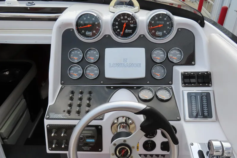  Yacht Photos Pics Dashboard of a 2007 Donzi 35 ZR boat with gauges and steering wheel.
