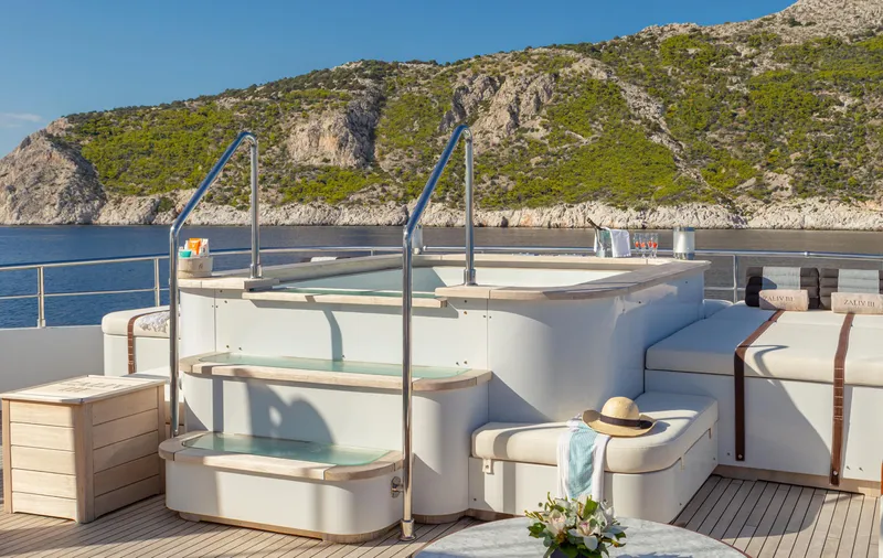 Zaliv III Yacht Photos Pics Luxurious Mondomarine yacht deck with jacuzzi, scenic coastal backdrop, 2011 Semi Displacement model.