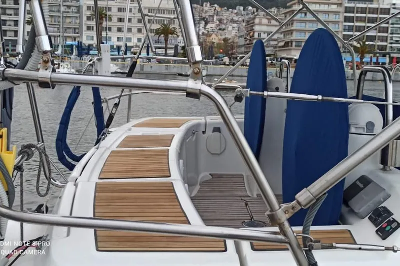 Pain Killer Yacht Photos Pics 2009 Beneteau Oceanis 46 yacht docked in a marina, featuring teak deck and urban backdrop.