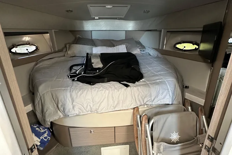  Yacht Photos Pics 2019 Formula 37 Performance Cruiser cabin with bed, portholes, and folded chair.