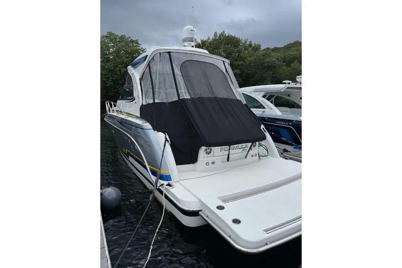  Yacht Photos Pics 2019 Formula 37 Performance Cruiser docked, featuring sleek design and covered cockpit.