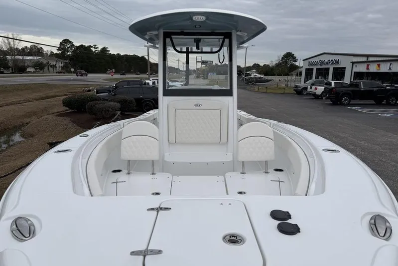  Yacht Photos Pics 2026 Sea Hunt Ultra 265 SE boat with spacious deck and seating, displayed outdoors.