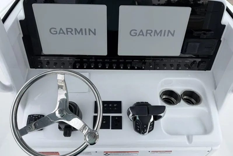  Yacht Photos Pics Steering console of 2026 Sea Hunt Ultra 265 SE with Garmin displays and controls.