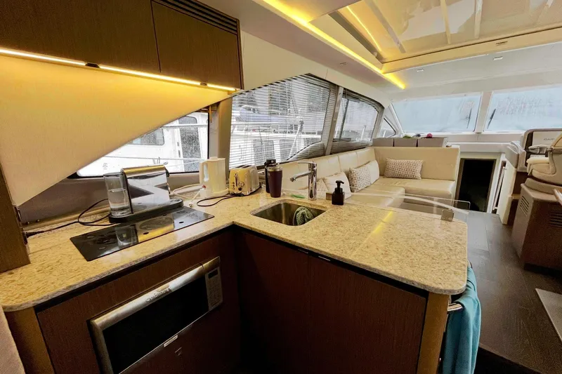 Empyrean Yacht Photos Pics Luxurious 2019 Sea Ray Sundancer 460 yacht interior with modern kitchen and cozy seating area.