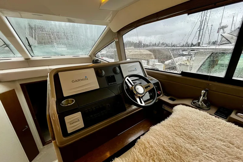 Empyrean Yacht Photos Pics 2019 Sea Ray Sundancer 460 helm with Garmin navigation, rainy marina view.