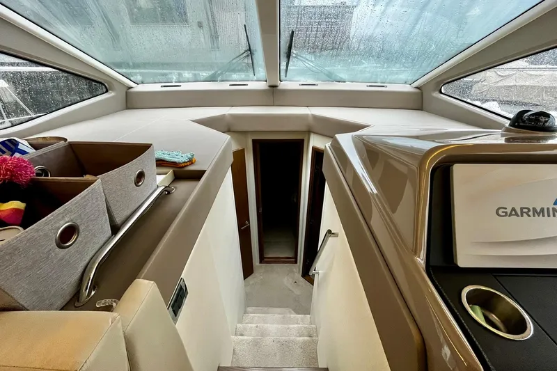 Empyrean Yacht Photos Pics Interior view of 2019 Sea Ray Sundancer 460 yacht with stairs and storage bins.