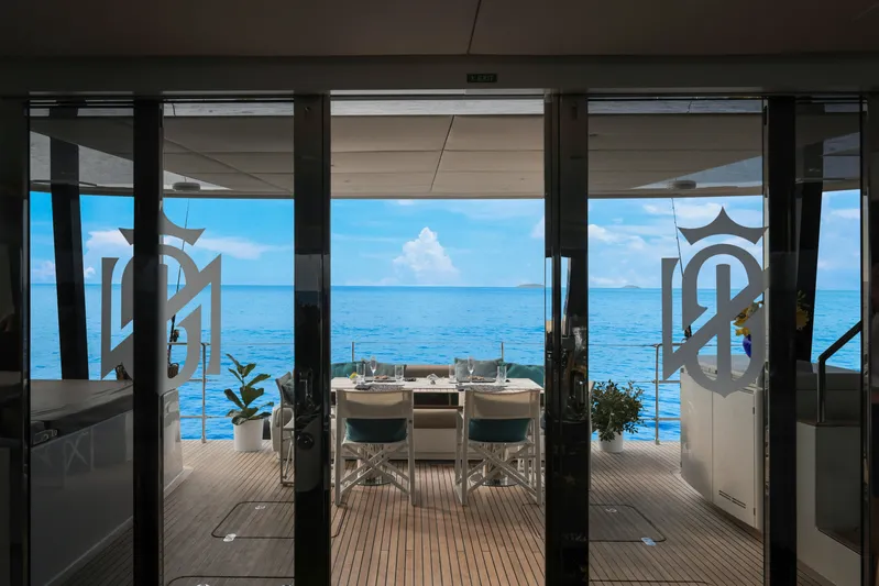 Sinata Yacht Photos Pics Luxurious Sunreef 60 yacht interior with ocean view, featuring elegant dining setup, 2019 model.
