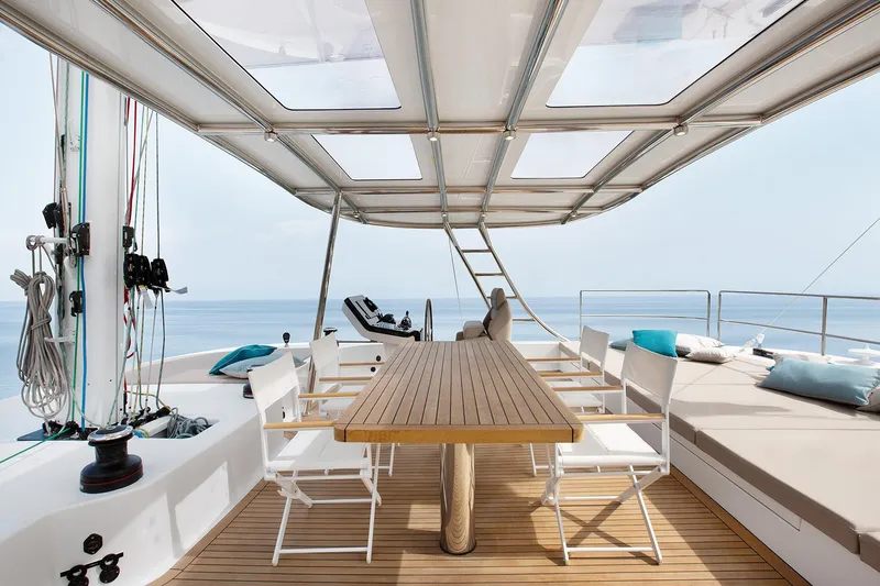 Sinata Yacht Photos Pics Luxurious Sunreef 60 yacht deck with dining area and ocean view, 2019 model.