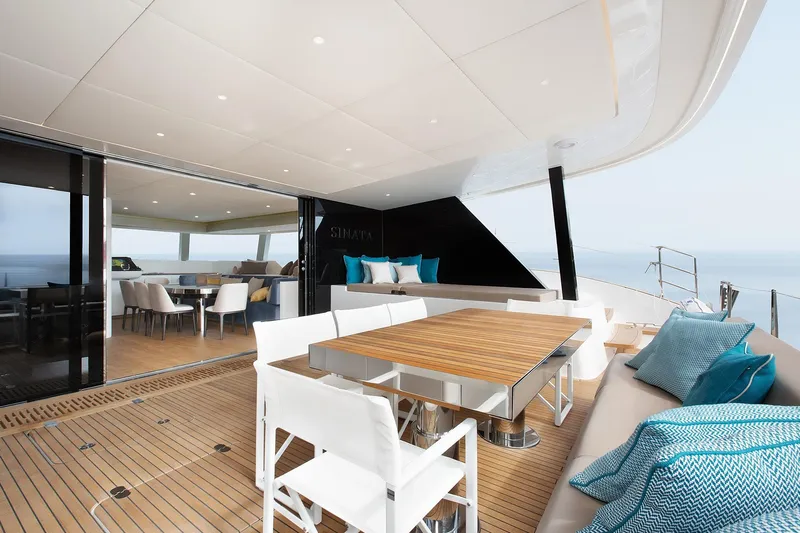 Sinata Yacht Photos Pics Luxurious 2019 Sunreef 60 yacht deck with elegant dining area and ocean view.