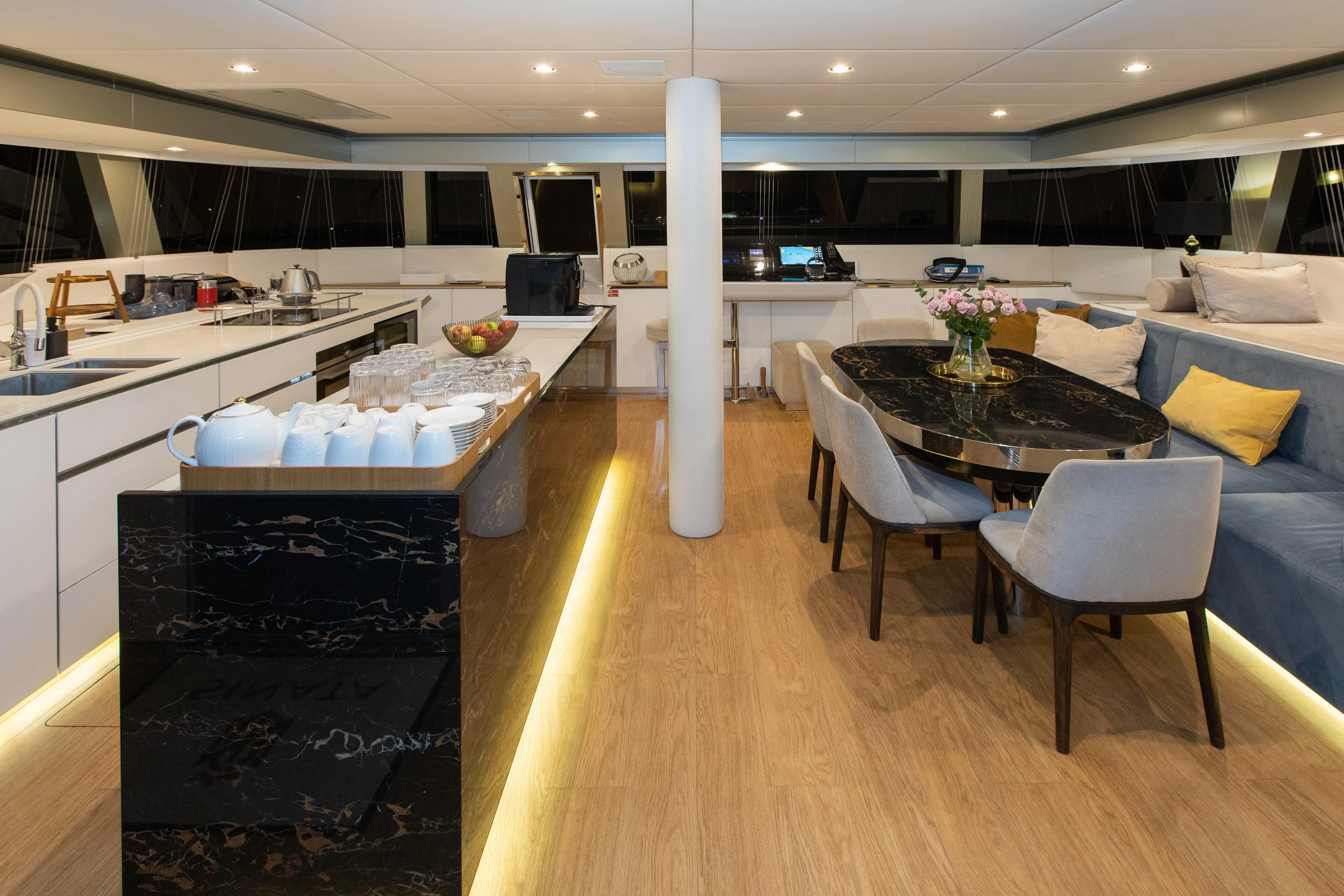 Sinata Yacht Photos Pics Luxurious interior of 2019 Sunreef 60 yacht with modern kitchen and elegant dining area.