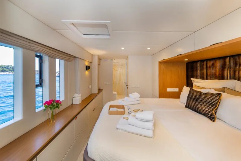 Sinata Yacht Photos Pics Luxurious Sunreef 60 yacht bedroom interior, 2019 model, with ocean view and elegant decor.