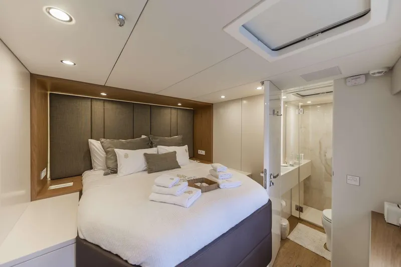 Sinata Yacht Photos Pics Luxurious Sunreef 60 yacht bedroom with ensuite bathroom, modern design, and elegant decor, 2019 model.