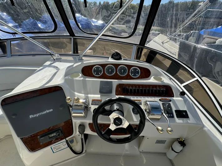 Baby Cake Yacht Photos Pics Helm of 2004 Meridian 381 Sedan with steering wheel and navigation instruments.